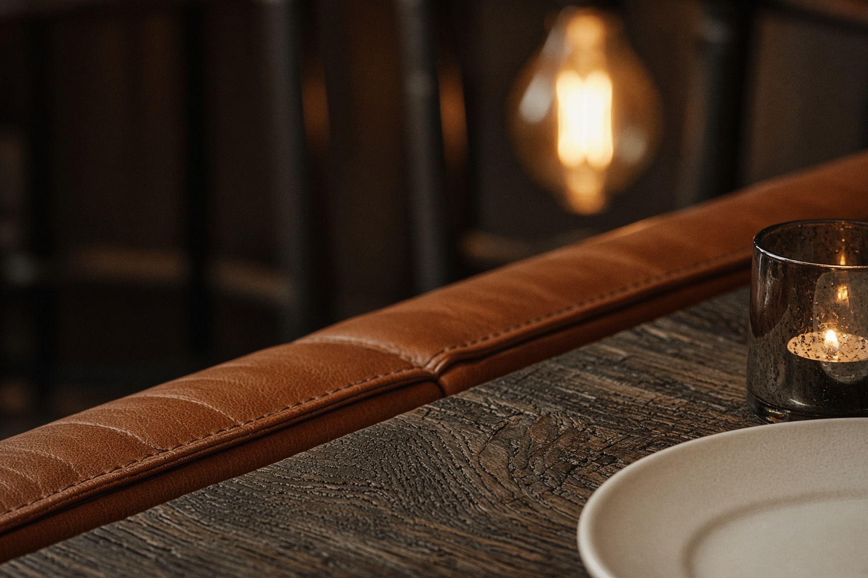 Weathered oak grain and cognac leather stitching